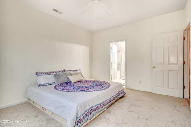 carpeted bedroom featuring ceiling fan and ensuite bath