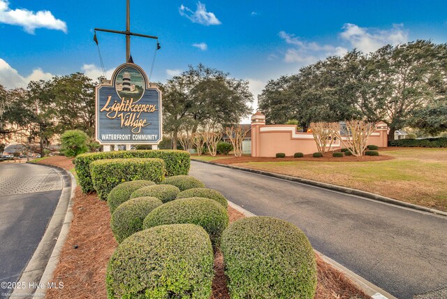 community / neighborhood sign featuring a lawn