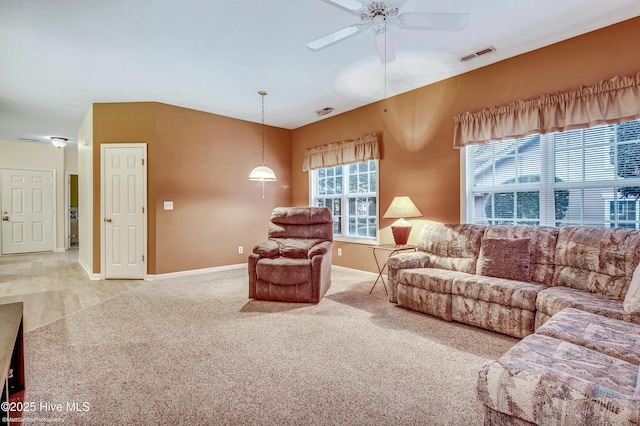 carpeted living room with ceiling fan