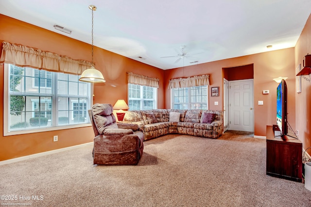 carpeted living room featuring ceiling fan and a healthy amount of sunlight