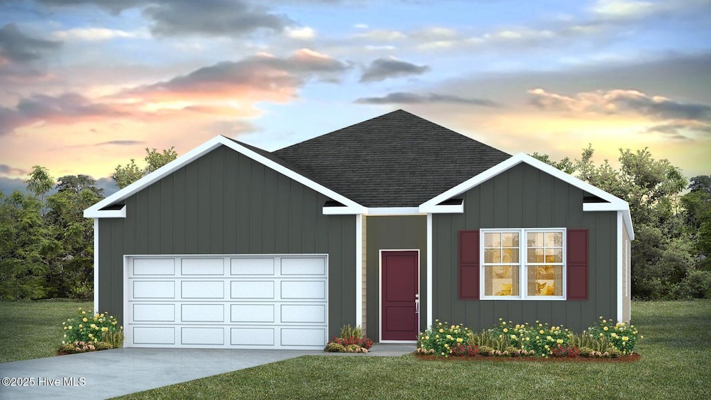 view of front of home featuring a garage and a lawn