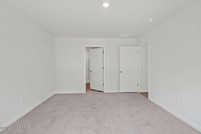 unfurnished bedroom with light carpet