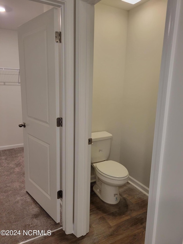 bathroom featuring hardwood / wood-style floors and toilet