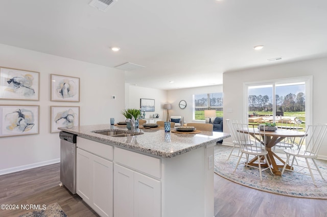 kitchen featuring white cabinetry, a kitchen island with sink, light stone countertops, stainless steel dishwasher, and sink