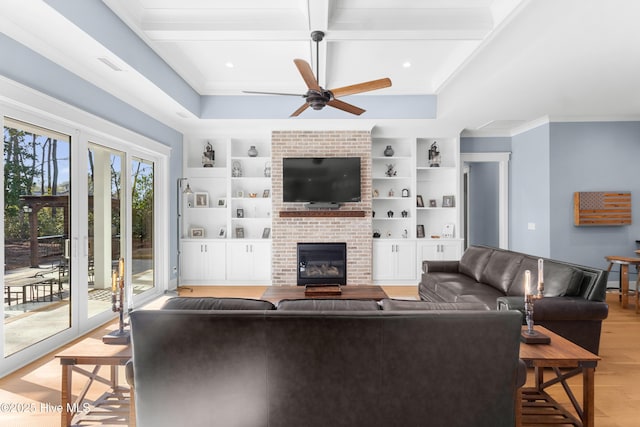 living room featuring a fireplace, built in features, light hardwood / wood-style floors, and beamed ceiling