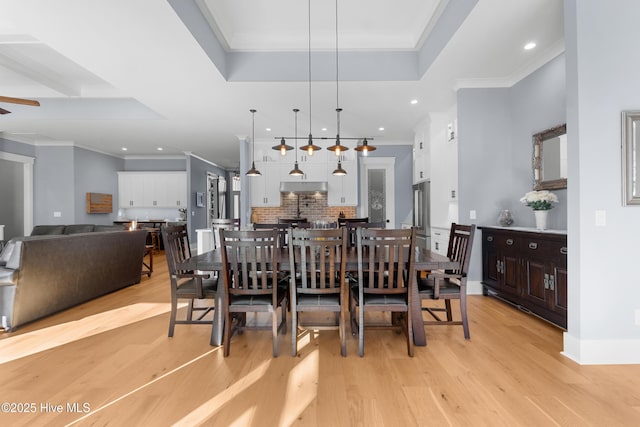 dining area featuring crown molding, ceiling fan, and light hardwood / wood-style floors