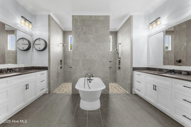 bathroom featuring ornamental molding, independent shower and bath, and vanity