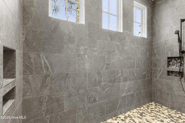 bathroom featuring a tile shower