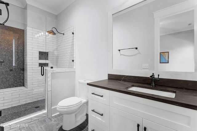 bathroom featuring vanity, a shower with shower door, and toilet