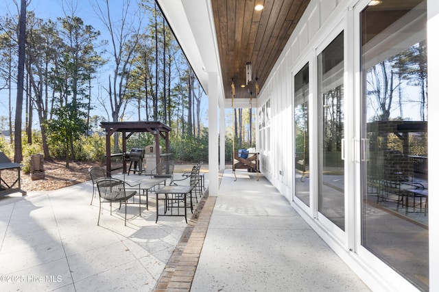 view of patio with area for grilling and a gazebo