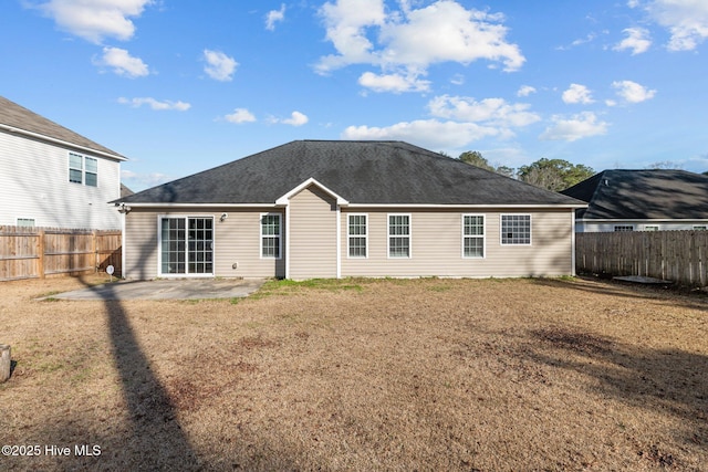 back of house with a patio area and a lawn