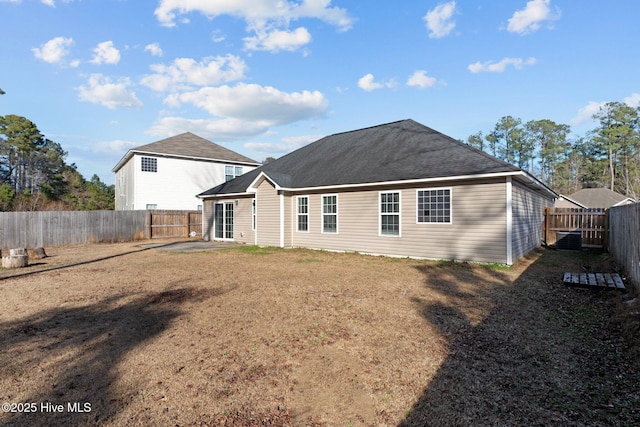 rear view of property with a patio and a lawn