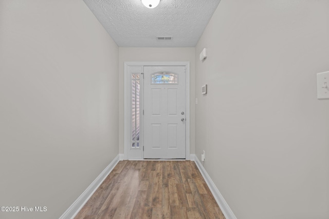 entryway featuring hardwood / wood-style floors and a textured ceiling