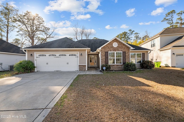 single story home with central AC unit and a garage