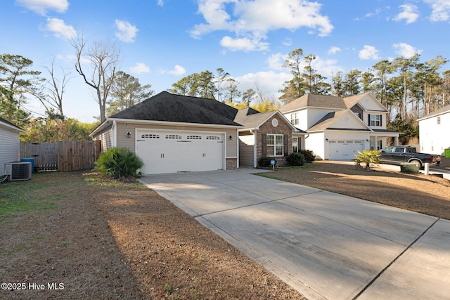 view of front of home with a garage and central air condition unit