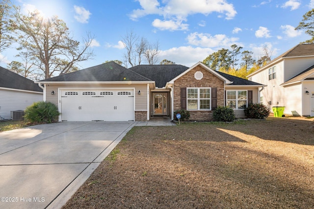 view of front of home with a garage and central air condition unit