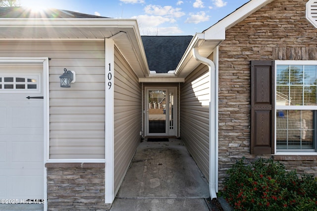 doorway to property with a garage