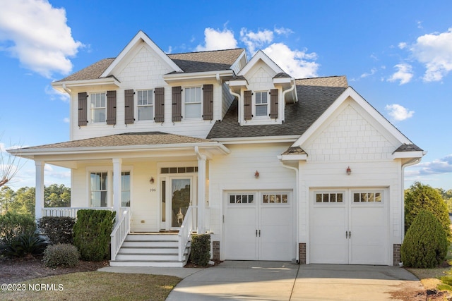 view of front of property with a porch and a garage