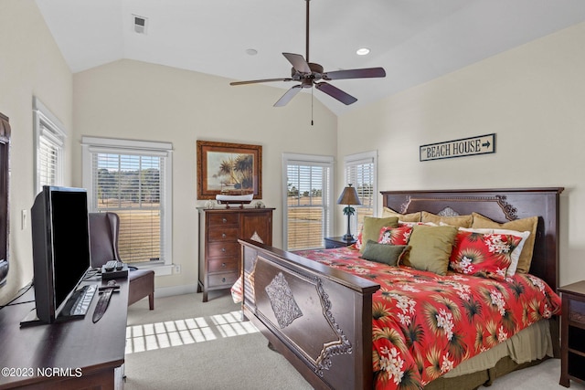 carpeted bedroom with ceiling fan, multiple windows, and vaulted ceiling