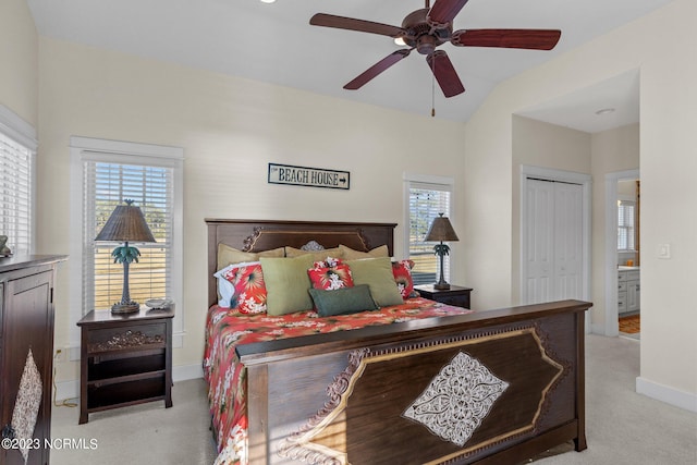 bedroom with ceiling fan, lofted ceiling, a closet, and light carpet