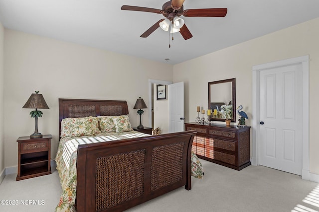 bedroom featuring light carpet and ceiling fan