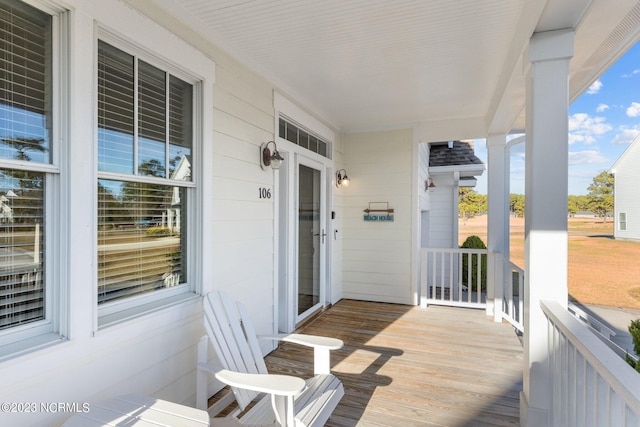 wooden terrace featuring covered porch