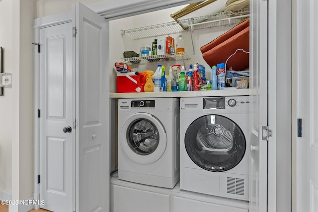 clothes washing area featuring washer and dryer