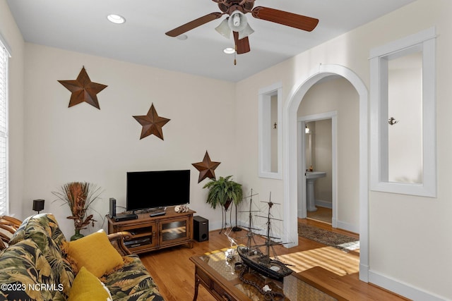 living room with ceiling fan and light wood-type flooring