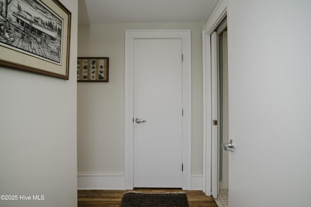 corridor featuring dark hardwood / wood-style floors