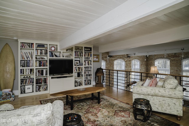 living room featuring wood-type flooring, wooden ceiling, brick wall, and beam ceiling