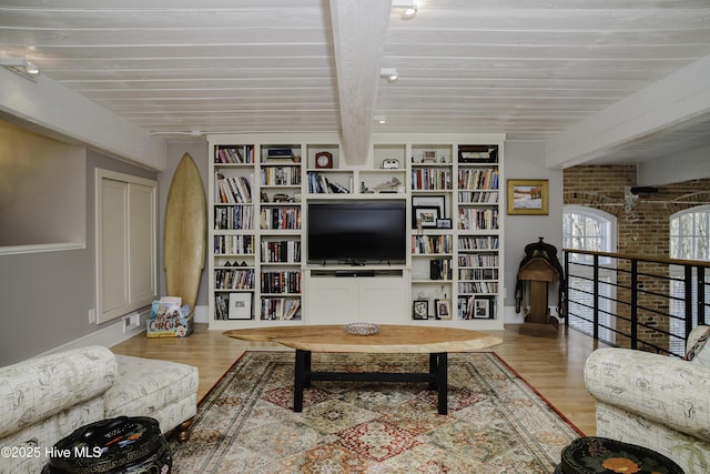 living room featuring light hardwood / wood-style flooring and beamed ceiling