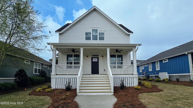 back of house with a water view and covered porch