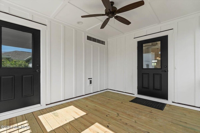 1665 Butterfly Knot Dr SW, Ocean Isle Beach, NC 28469 - property entrance with board and batten siding, a ceiling fan, and a wooden deck