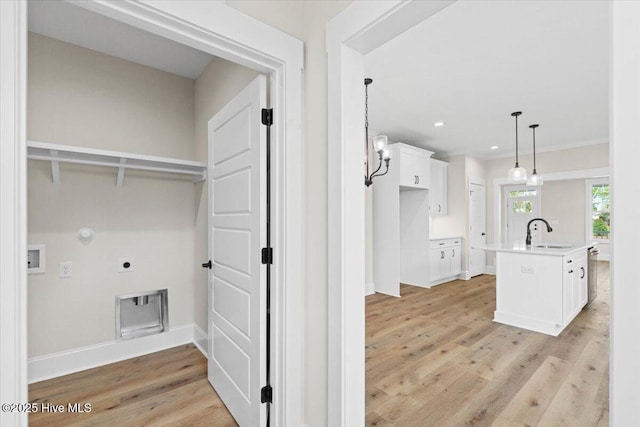 1665 Butterfly Knot Dr SW, Ocean Isle Beach, NC 28469 - washroom featuring hookup for an electric dryer, a sink, hookup for a gas dryer, light wood finished floors, and baseboards