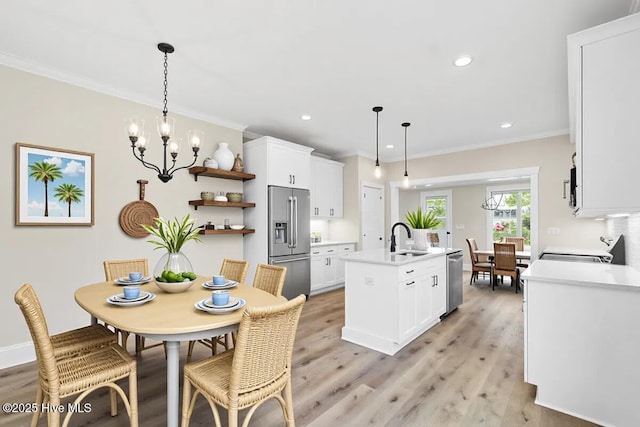 1665 Butterfly Knot Dr SW, Ocean Isle Beach, NC 28469 - dining space featuring ornamental molding, light wood-style floors, a chandelier, and recessed lighting