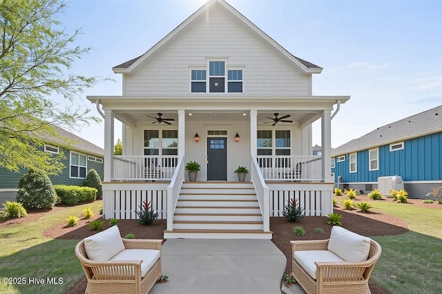 1665 Butterfly Knot Dr SW, Ocean Isle Beach, NC 28469 - view of front facade with a ceiling fan, covered porch, a front yard, and stairway