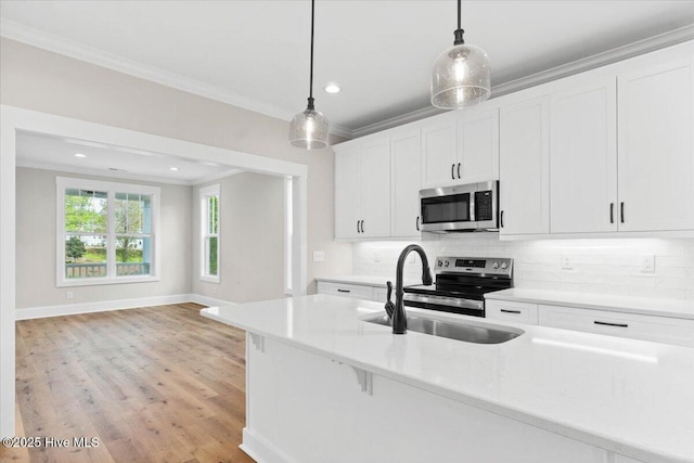 1665 Butterfly Knot Dr SW, Ocean Isle Beach, NC 28469 - kitchen with appliances with stainless steel finishes, ornamental molding, backsplash, recessed lighting, and hanging light fixtures