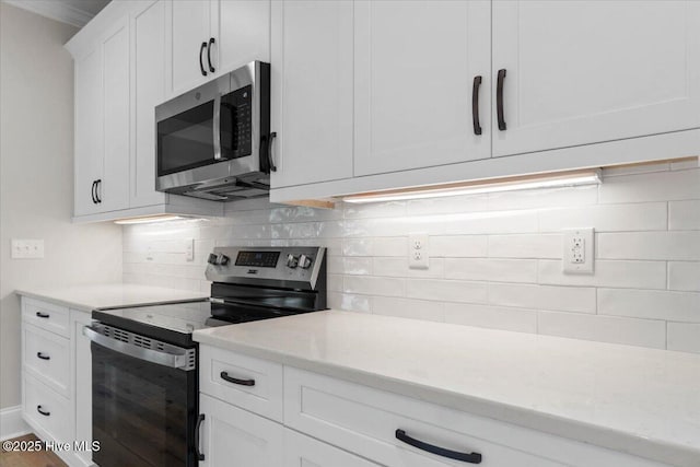 1665 Butterfly Knot Dr SW, Ocean Isle Beach, NC 28469 - kitchen with appliances with stainless steel finishes, backsplash, and white cabinetry
