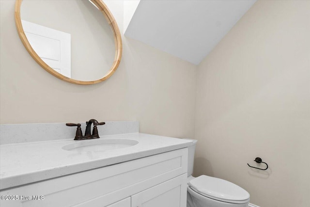 1665 Butterfly Knot Dr SW, Ocean Isle Beach, NC 28469 - bathroom featuring vanity, toilet, and lofted ceiling