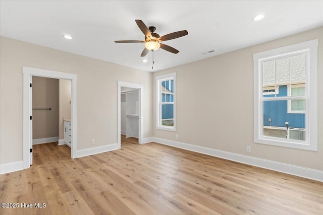 1665 Butterfly Knot Dr SW, Ocean Isle Beach, NC 28469 - unfurnished bedroom featuring light wood-style flooring, a walk in closet, baseboards, recessed lighting, and a closet