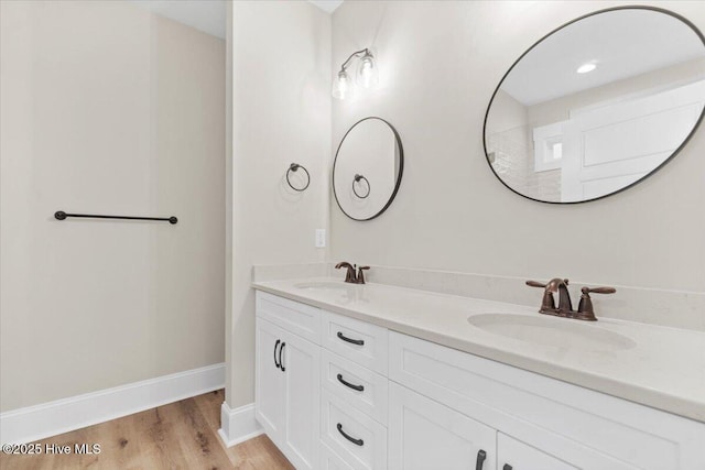 1665 Butterfly Knot Dr SW, Ocean Isle Beach, NC 28469 - bathroom with wood finished floors, double vanity, and baseboards