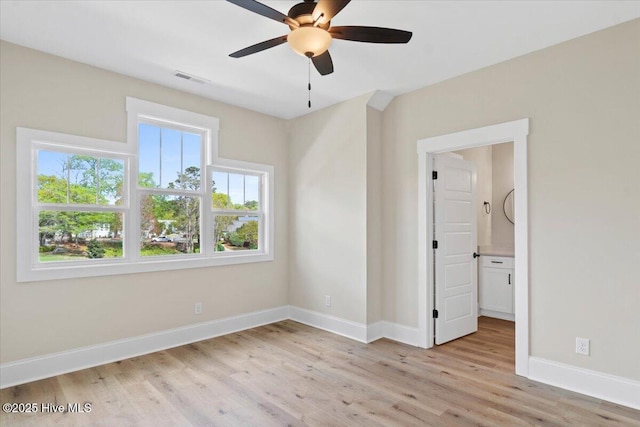 1665 Butterfly Knot Dr SW, Ocean Isle Beach, NC 28469 - spare room with light wood-style flooring, ceiling fan, and baseboards