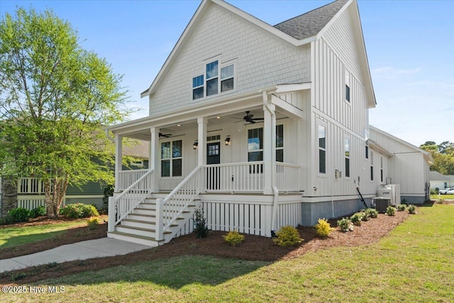 1665 Butterfly Knot Dr SW, Ocean Isle Beach, NC 28469 - view of front of home featuring ceiling fan, a porch, a front yard, board and batten siding, and central air condition unit