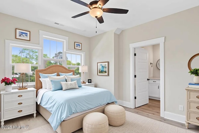 1665 Butterfly Knot Dr SW, Ocean Isle Beach, NC 28469 - bedroom featuring baseboards, light wood-style floors, ensuite bathroom, and a ceiling fan