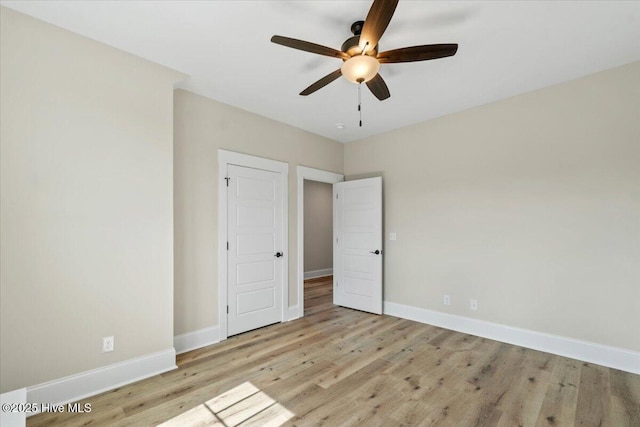 1665 Butterfly Knot Dr SW, Ocean Isle Beach, NC 28469 - unfurnished bedroom with wood finished floors, baseboards, and ceiling fan