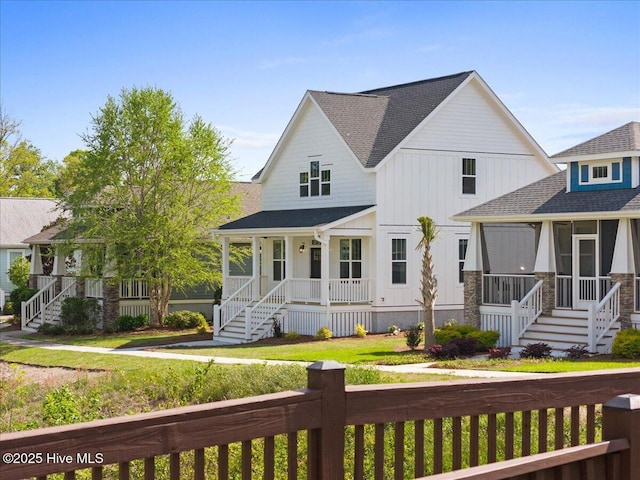 1665 Butterfly Knot Dr SW, Ocean Isle Beach, NC 28469 - view of front of property with covered porch, roof with shingles, stairs, a sunroom, and board and batten siding