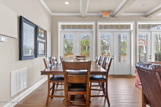 1665 Butterfly Knot Dr SW, Ocean Isle Beach, NC 28469 - dining area featuring french doors, wood finished floors, beamed ceiling, baseboards, and ornamental molding