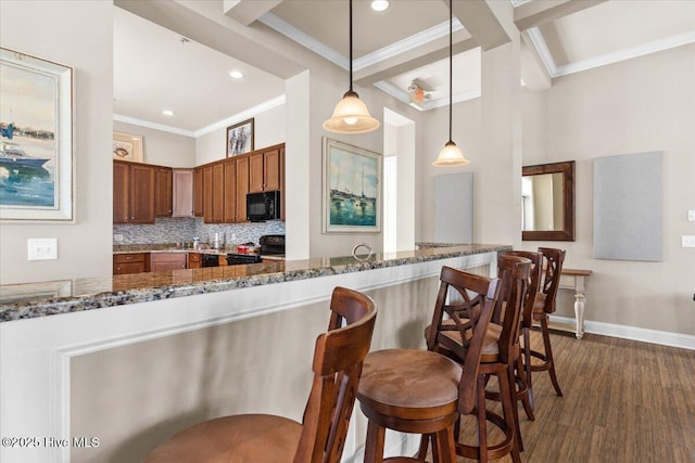 1665 Butterfly Knot Dr SW, Ocean Isle Beach, NC 28469 - kitchen featuring black appliances, crown molding, dark stone counters, baseboards, and decorative backsplash