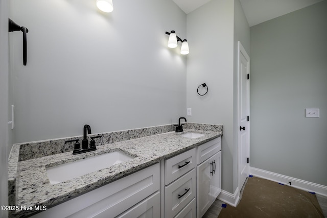 682 Crump Farm Rd, New Bern, NC 28562 - bathroom with double vanity, a sink, and baseboards