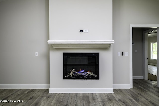 682 Crump Farm Rd, New Bern, NC 28562 - interior details with a glass covered fireplace, wood finished floors, and baseboards